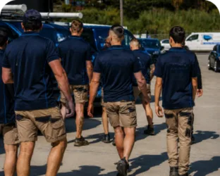 Plumbers walking to their service vans on a Chiswick job